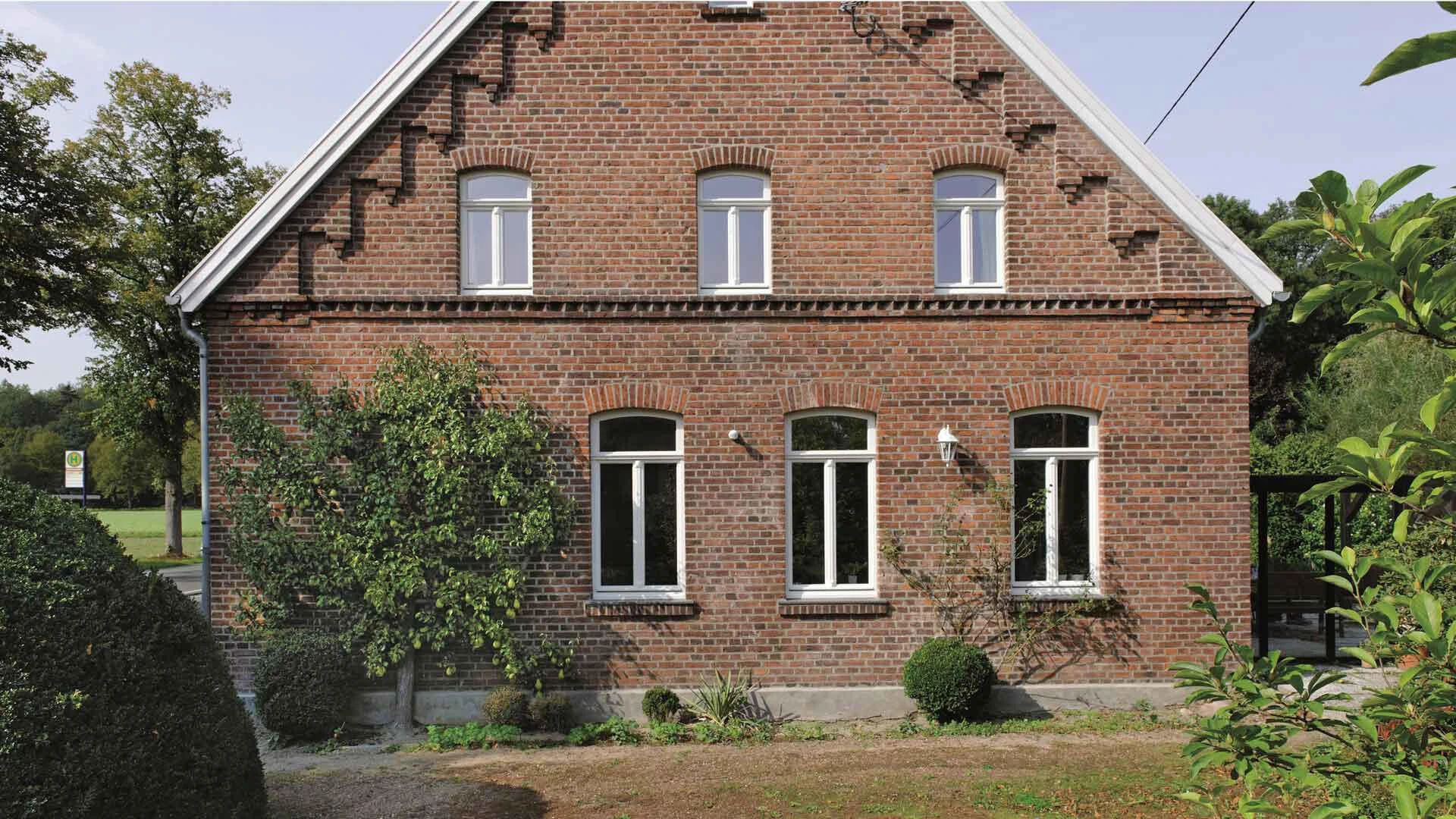 Aufnahme einer Backsteinfassade im Grünen